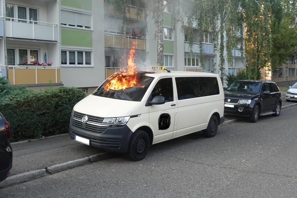 Plötzlich stiegen Flammen aus dem Taxi auf.