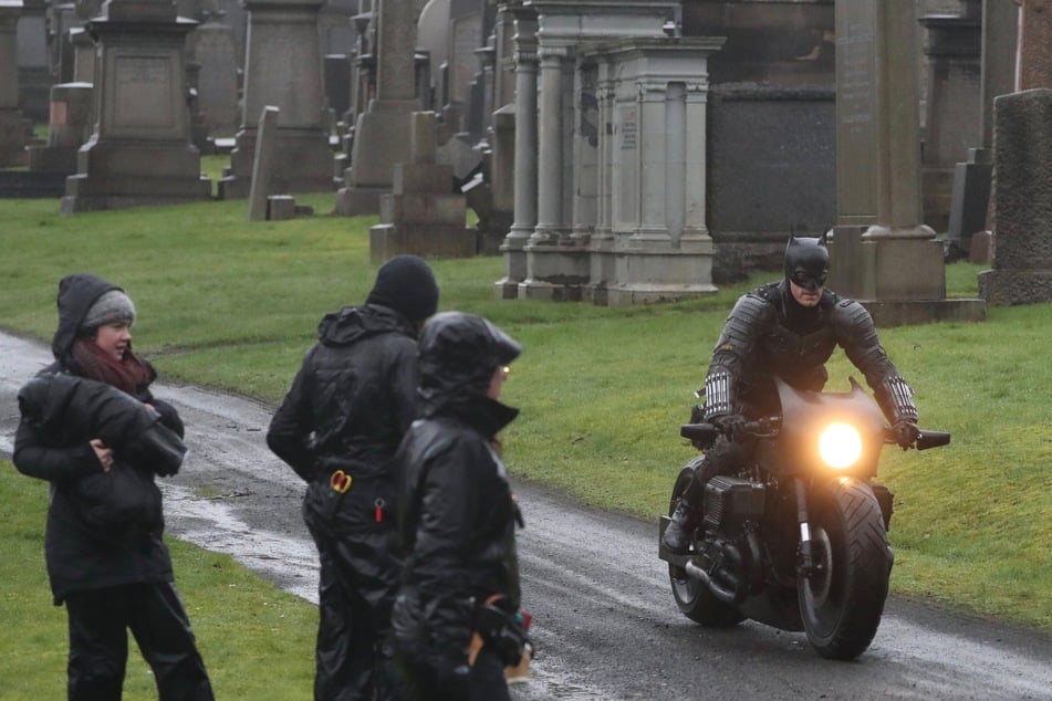 Batman riding his motorcycle through Glasgow Necropolis cemetery during filming.