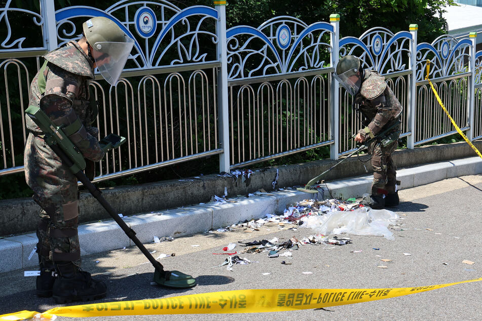 South Korean soldiers in Incheon examine various objects and trash from a balloon believed to have been sent by North Korea.