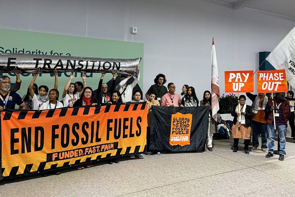 Climate activists stage a protest inside the COP29 venue to demand a phase-out of fossil fuels during the United Nations Climate Change Conference (COP29) in Baku on Friday.