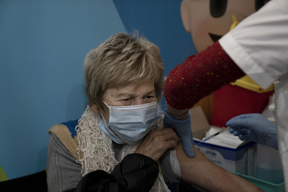 Israel: Eine Frau erhält ihre vierte Dosis des Coronavirus-Impfstoffs.