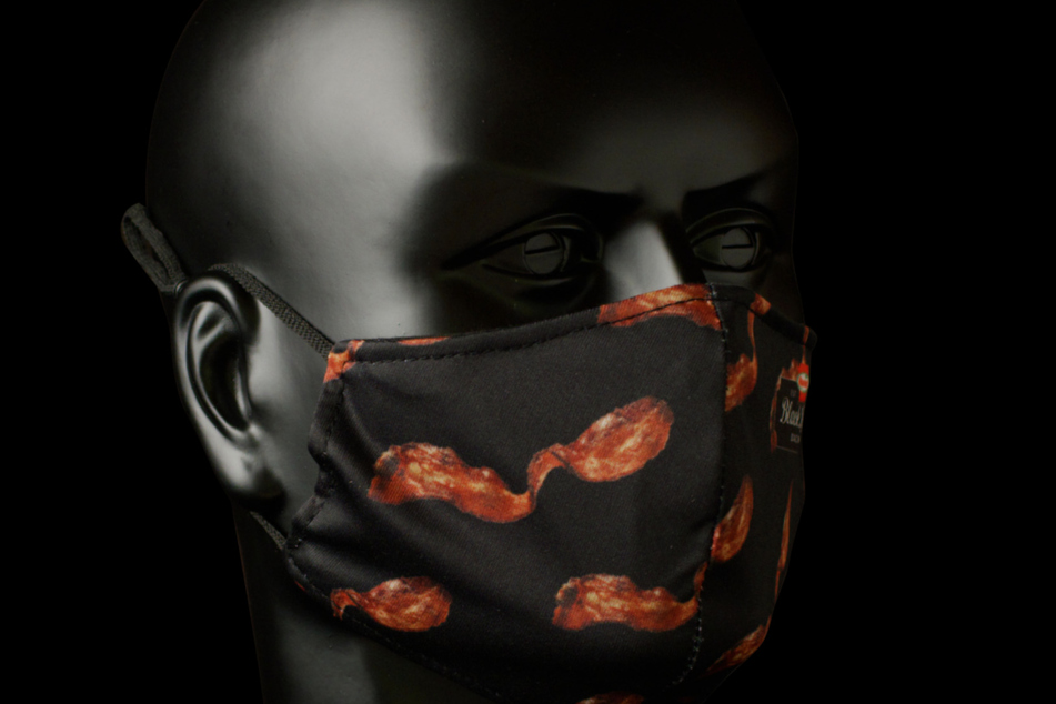 The mask is covered in stripes of bacon.