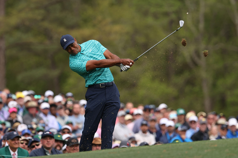 Tiger Woods tees off on the 12th during the second round. REUTERS/Mike Blake