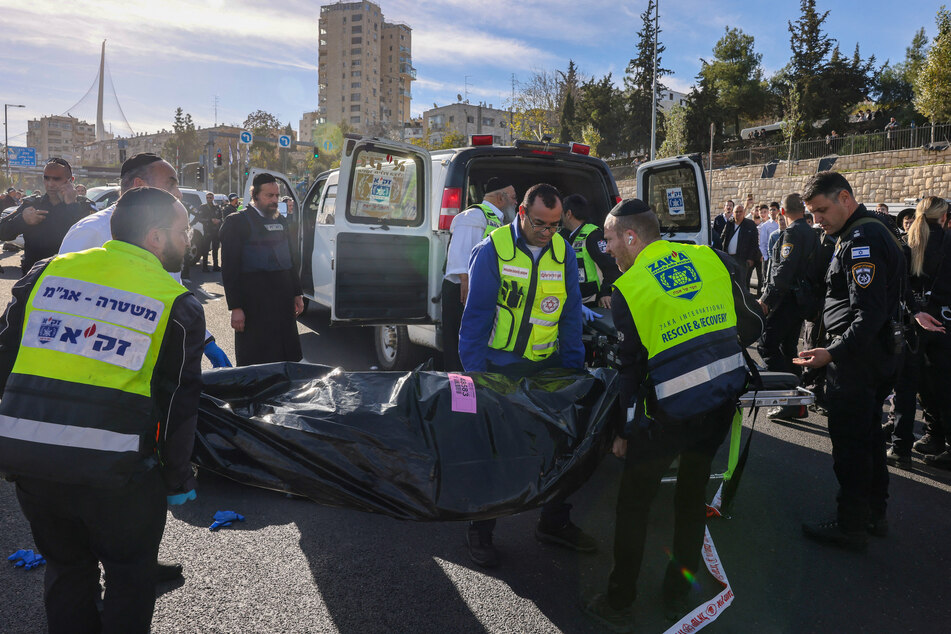 An Israeli rescue team places a body on a gurney at the site of a shooting in Jerusalem on Thursday.