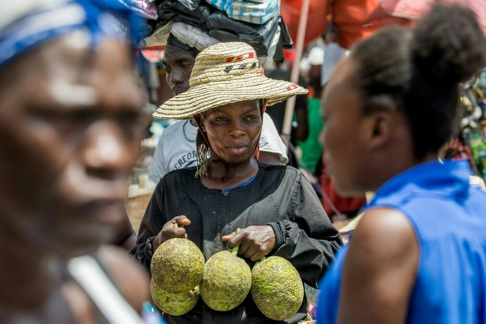 A woman sells goods on the street in Port-au-Prince.