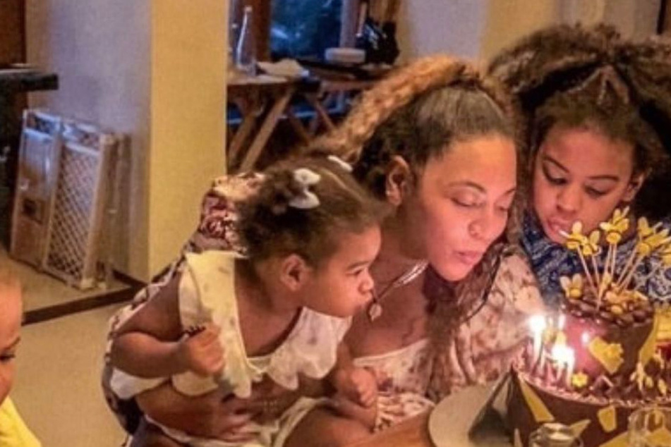Beyoncé's blows out her birthday candles with her children in a rare pic from the singer's private home life.