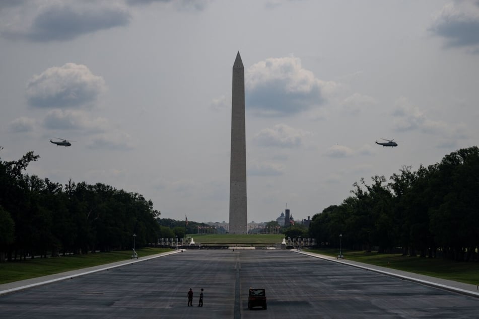 Marine One, carrying President Donald Trump, along with a support helicopter, depart over the National Mall in Washington DC on July 27, 2026.