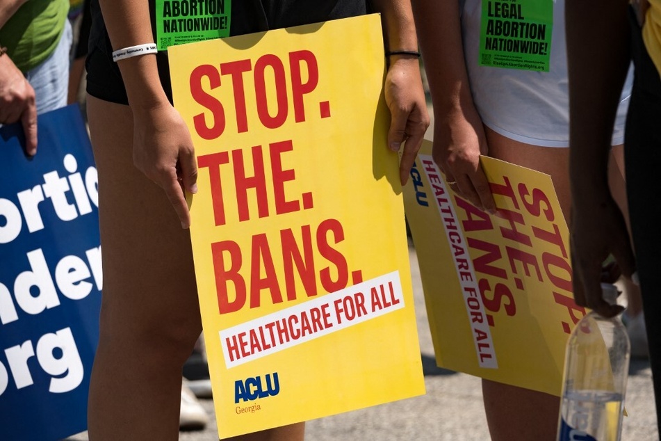 Protesters hold signs while marching and chanting through Downtown Atlanta in July 2022 in opposition to Georgia's new abortion law.