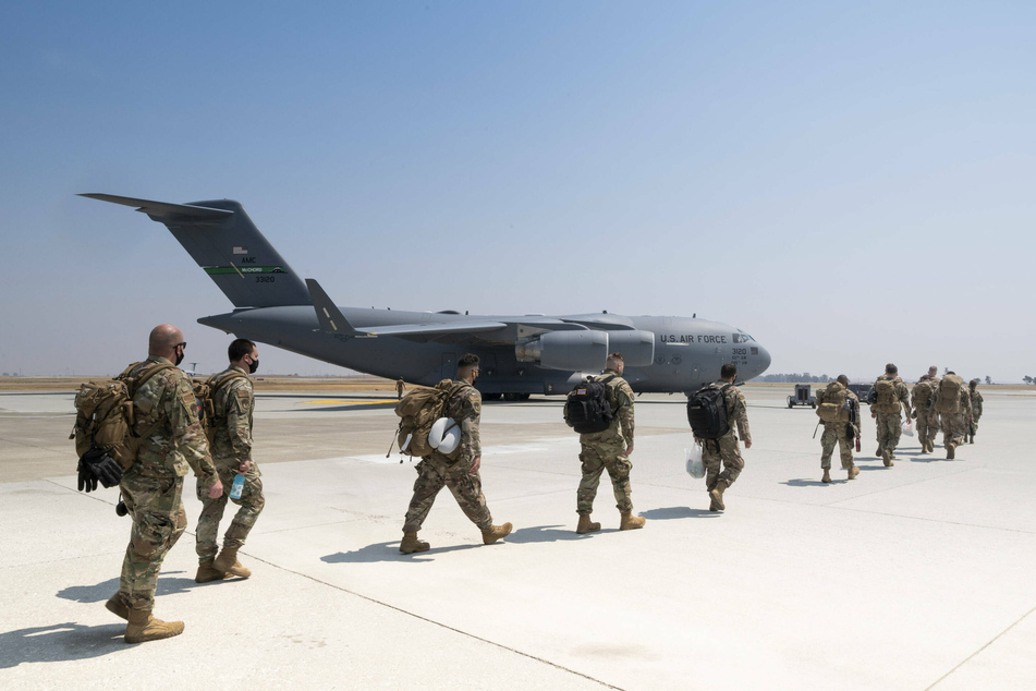 US Airmen board a C-17 Globemaster III cargo aircraft for deployment to Afghanistan at Travis Air Force Base.