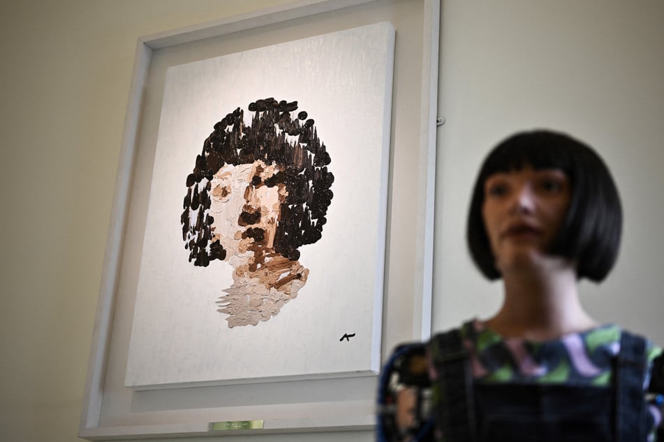 The robot artist Ai-Da, a humanoid powered by artificial intelligence, will be the first of its kind to have a painting sold at a major auction house, organizers said Wednesday.