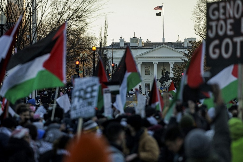 Protesters raise Palestinian flags and signs demanding a permanent ceasefire and an end to Biden administration for Israel's assault on Gaza in a rally outside the White House.