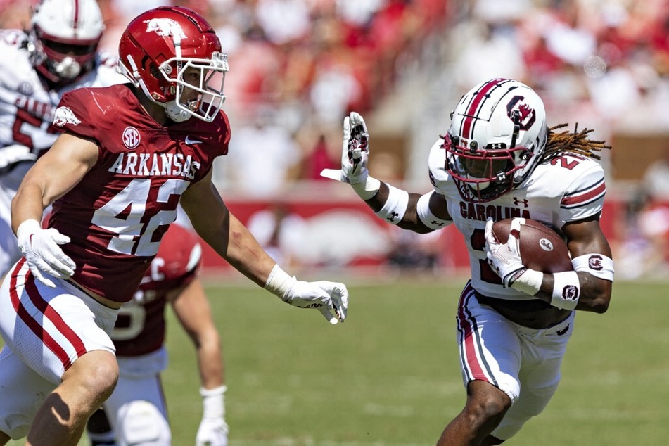 Juju McDowell (r) of the South Carolina Gamecocks runs the ball in the first half of its game against the Arkansas Razorbacks at Razorback Stadium.