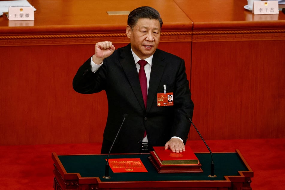 Chinese President Xi Jinping takes his oath during the Third Plenary Session of the National People's Congress at the Great Hall of the People in Beijing on March 10, 2023.