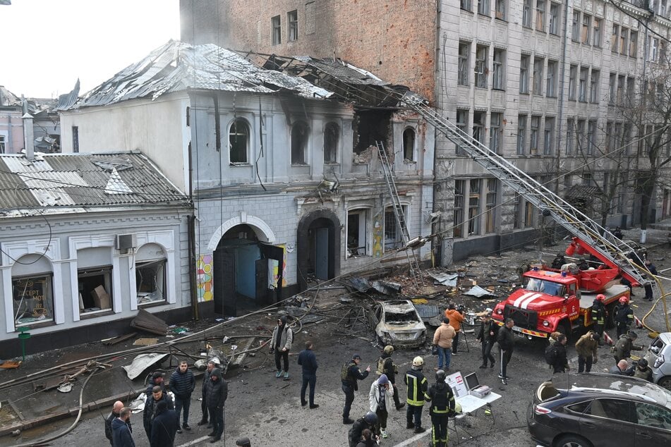 Ukrainian law enforcement officers work at the site of a drone attack that hit a kindergarten in Kharkiv on October 22, 2025.