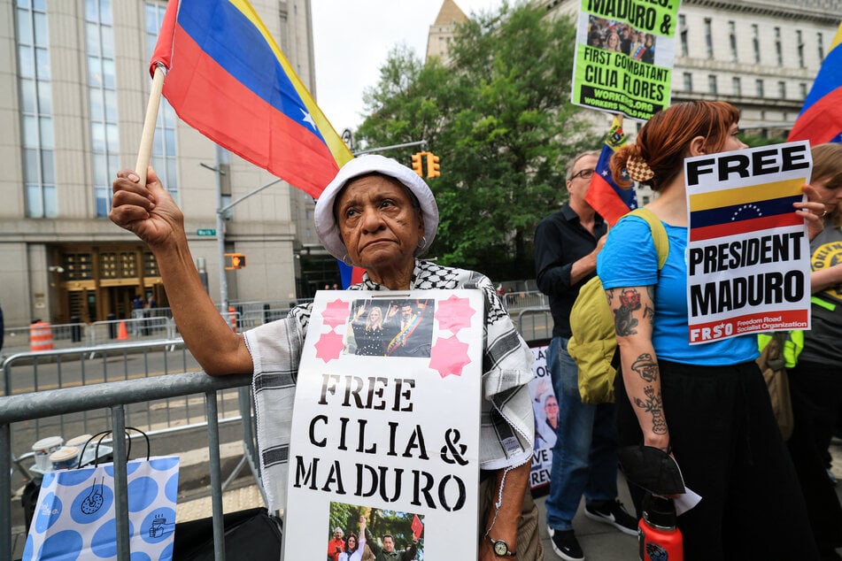Demonstrators hold signs in support of abducted Venezuelan President Nicholas Maduro and his wife Cilia Flores, outside the Daniel Patrick Moynihan Federal Courthouse in New York City on July 22, 2026.
