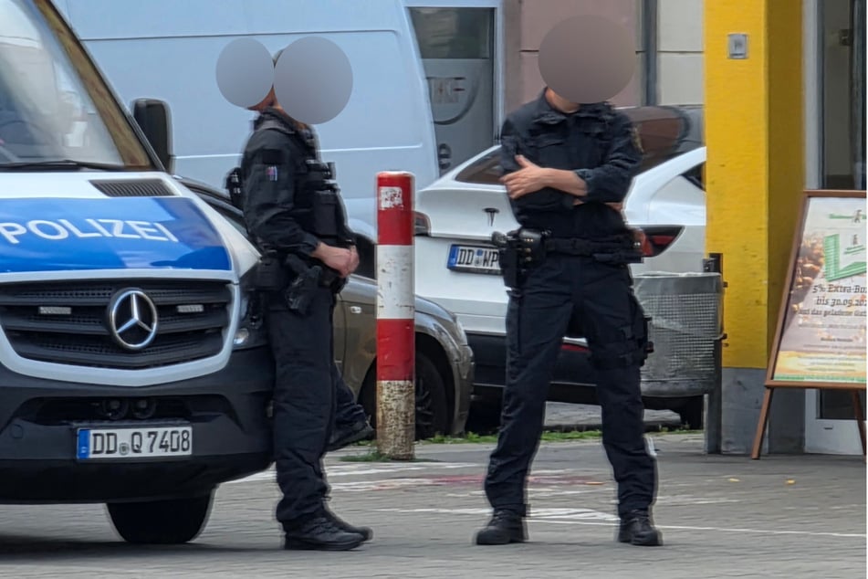 Polizeibeamte stehen vor einer Blutlache.
