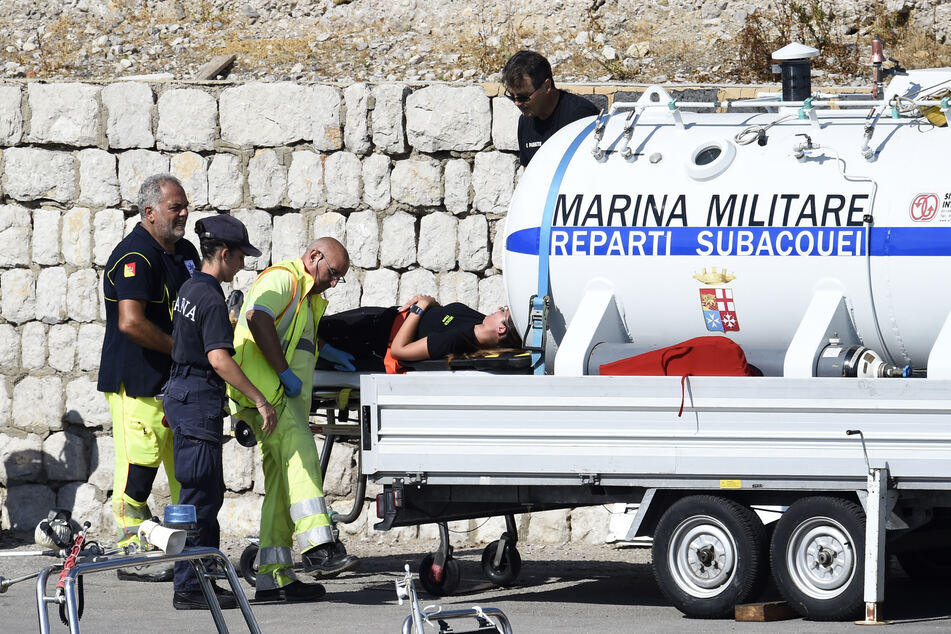 Taucher der italienischen Marine setzen eine Überdruckkammer ein, während sie am Ort der Suche nach einem vermissten Boot arbeiten.