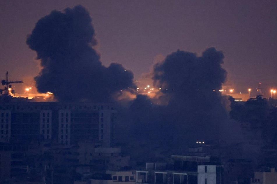 Smoke billows over Beirut's southern suburbs after an Israeli strike, as seen from Sin El Fil, Lebanon.