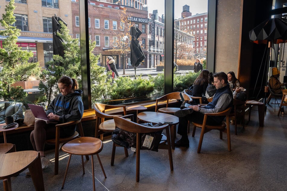 People use laptops inside of a Starbucks on Tuesday in New York City.