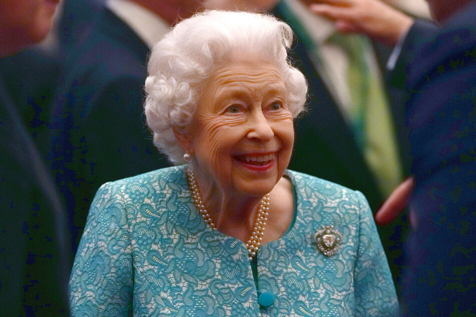 Queen Elizabeth II talks to guests including UK Prime Minister Boris Johnson at a reception for international business and investment leaders at Windsor Castle on October 19.