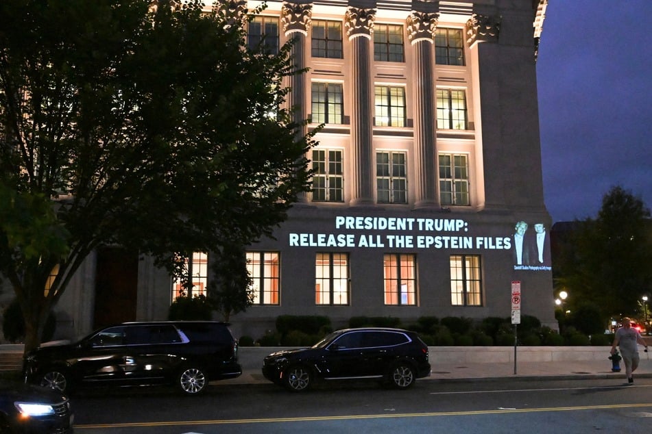 A message calling on President Donald Trump to release all files related to Jeffrey Epstein is projected onto the US Chamber of Commerce building across from the White House in Washington DC on July 18, 2025.