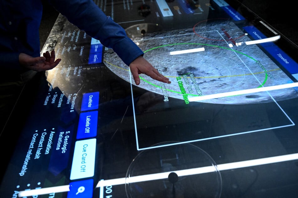 A worker uses a touch screen inside the Science Mission Operations Room (SMOR) at Johnson Space Center in Houston, Texas, on Monday.