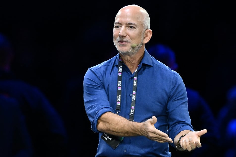 Amazon's founder Jeff Bezos (pictured) reacts as he speaks with Stellantis' Chairman John Elkann on stage during the Italian Tech Week 2025, at OGR Officine Grandi Riparazioni, in Turin, northern Italy, on Friday.