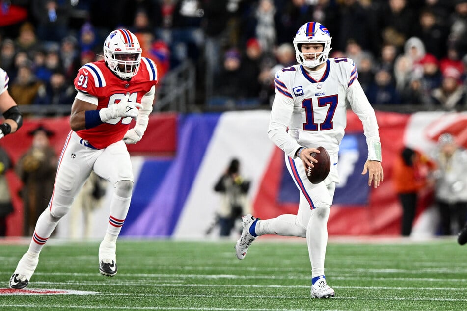 Buffalo Bills quarterback Josh Allen runs with the ball against the New England Patriots during the second half at Gillette Stadium.