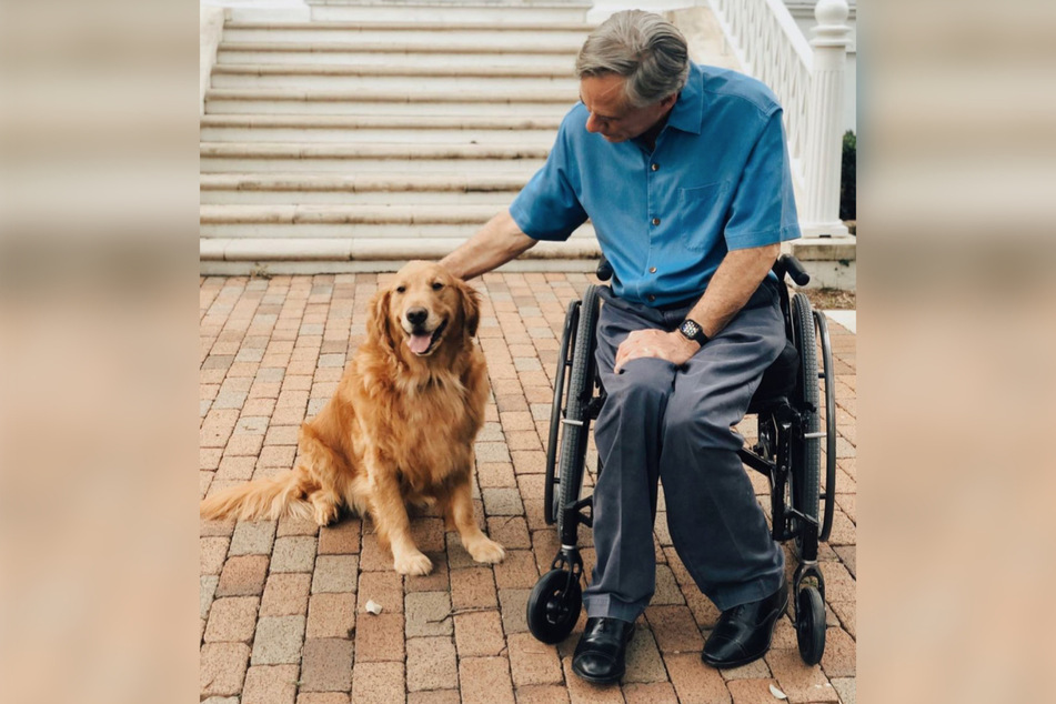 Texas Governor Greg Abbott poses with his golden retriever Pancake.