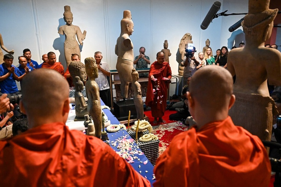 Buddhist monks take part in a repatriation ceremony for Angkorian artifacts returned from the US at the National Museum in Phnom Penh, Cambodia.