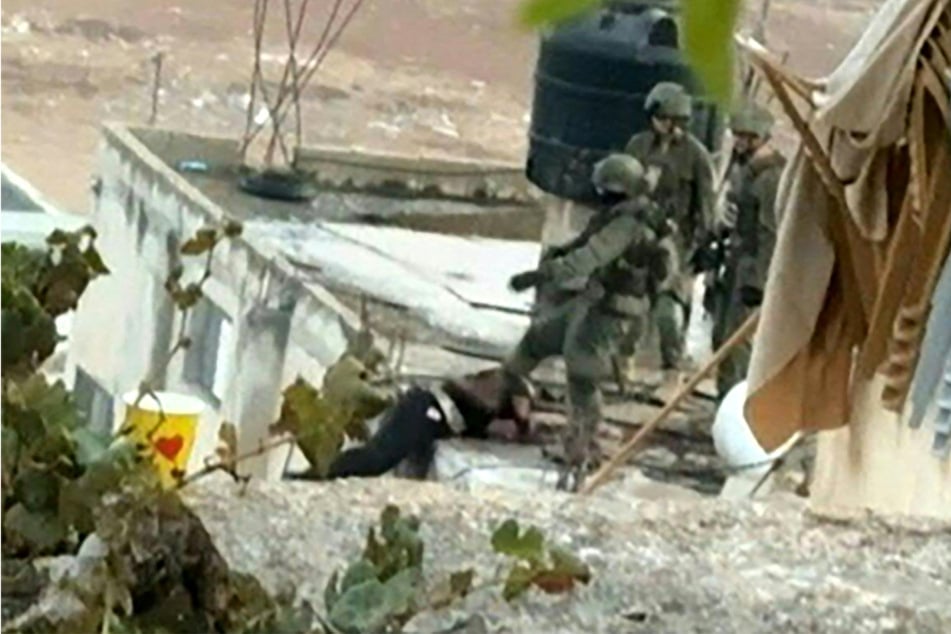 Footage of an Israeli raid in the occupied West Bank showed a soldier pushing an apparently dead man off a rooftop in what the army described Friday as a "serious incident".