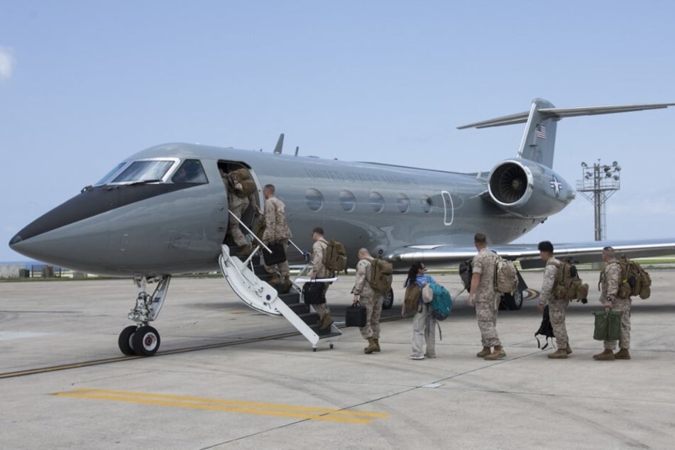 US Marines board a Citation Ultra aircraft at Kadena Air Base in Okinawa.