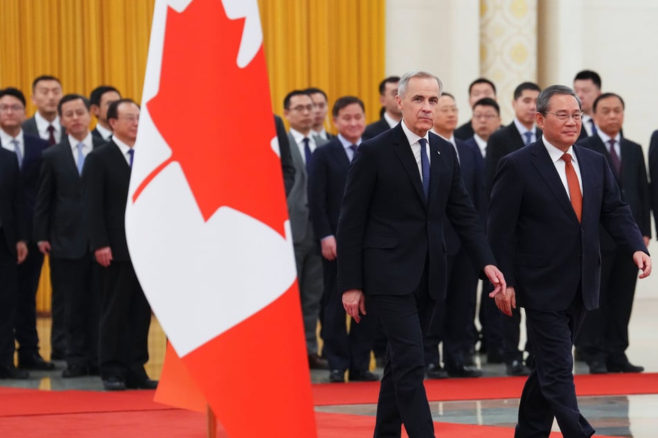 Beijing's top diplomat touted a "turning point" in China-Canada relations only hours after Prime Minister Mark Carney (c.) was welcomed to Beijing by Chinese Premier Li Qiang (r.).