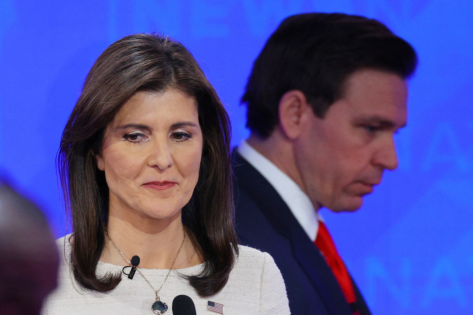 Florida Governor Ron DeSantis walks past former US Ambassador to the United Nations Nikki Haley during a break in the fourth 2024 Republican candidates' presidential debate at the University of Alabama in Tuscaloosa, on December 6, 2023.