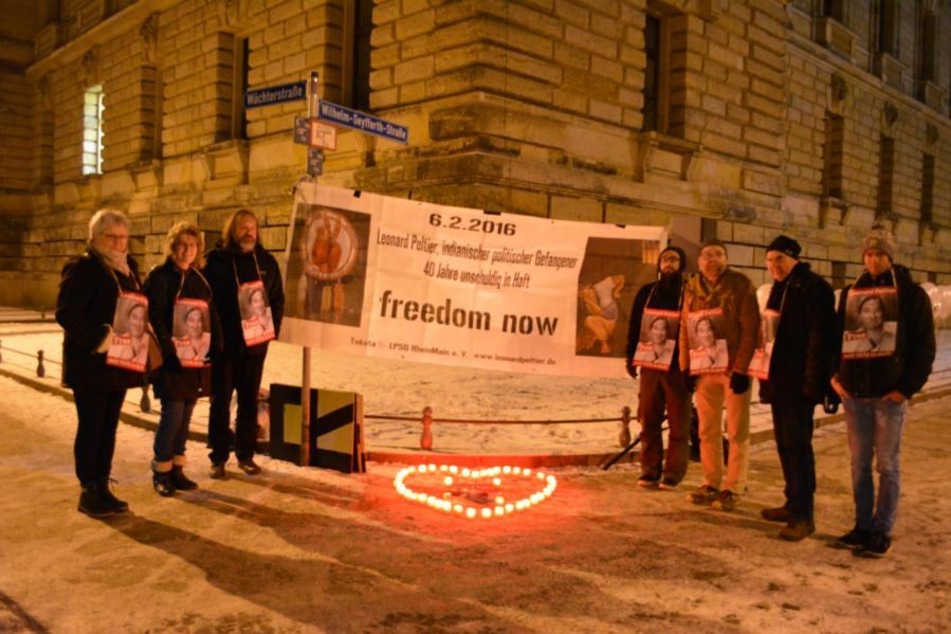 German activists wear signs calling for Leonard Peltier's release during a 2017 vigil in front of the US Consulate in Leipzig.