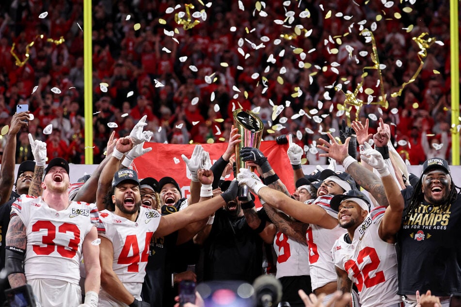 The Ohio State Buckeyes celebrate after beating the Notre Dame Fighting Irish in the CFP National Championship college football game at Mercedes-Benz Stadium in Atlanta, Georgia.