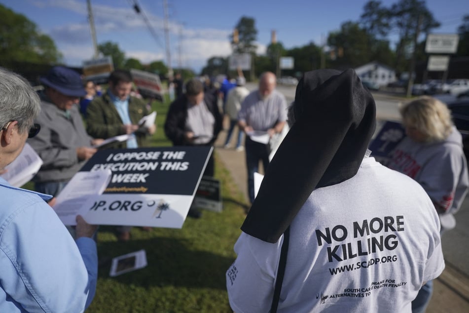 People pray outside the Department of Corrections in Columbia, South Carolina, before the scheduled firing squad execution of Mikal Mahdi on April 11, 2025.