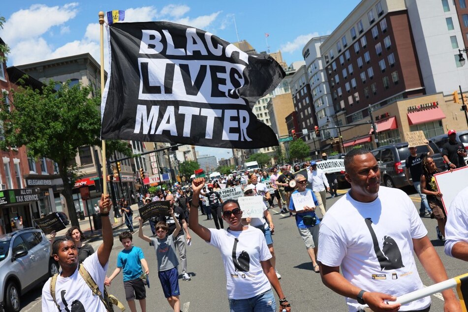 Demonstrators join a Newark rally for reparations organized by the New Jersey Institute for Social Justice on Juneteenth 2022.