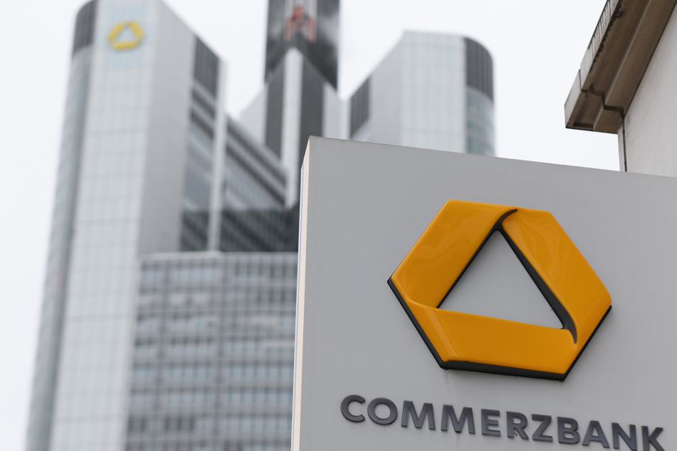 A Commerzbank branch sign is affixed to the facade of a house near Commerzbank headquarters.
