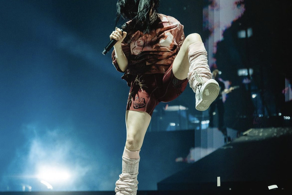 Billie Eilish rocking biker shorts while performing.