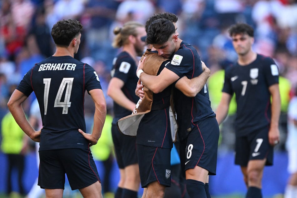 Christian Pulisic and Max Arfsten embrace after the match against Belgium following the US' elimination from the World Cup. 