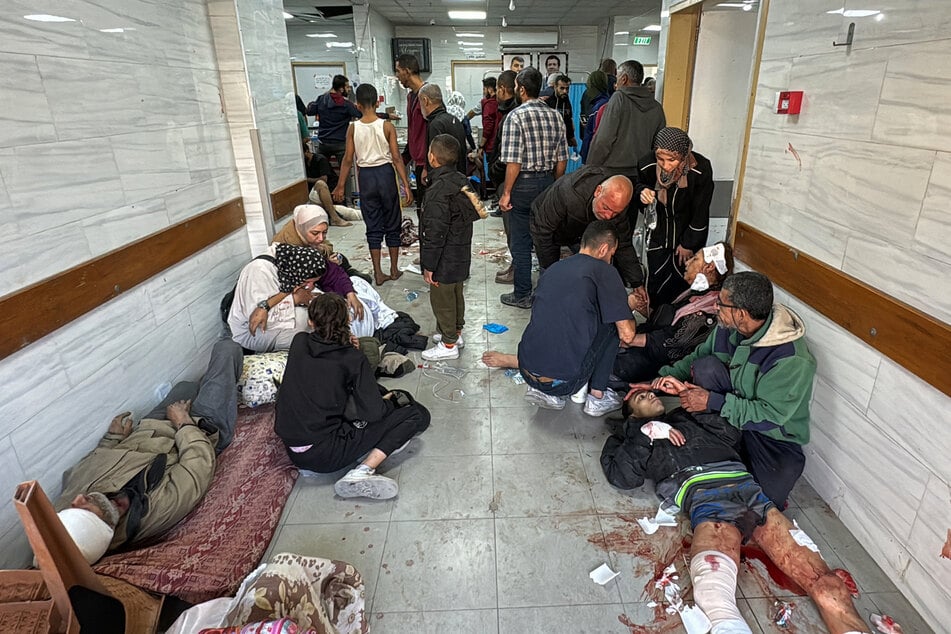 Palestinians injured in Israeli bombardment of the Beit Lahia Project area are laid on the floor awaiting treatment at the Kamal Adwan Hospital in Beit Lahia in the northern Gaza Strip on Wednesday amid the ongoing war between Israel and the Palestinian Hamas group.