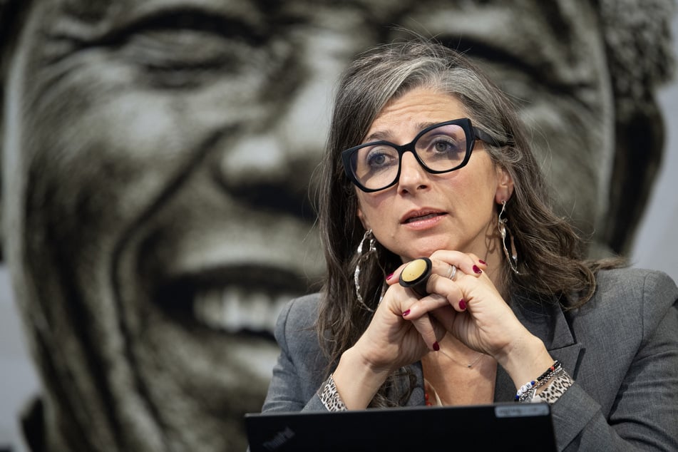 United Nations Special Rapporteur on the occupied Palestinian territories Francesca Albanese, sitting in front of an image of Nelson Mandela, addresses a press conference in Cape Town, South Africa, on October 28, 2025.