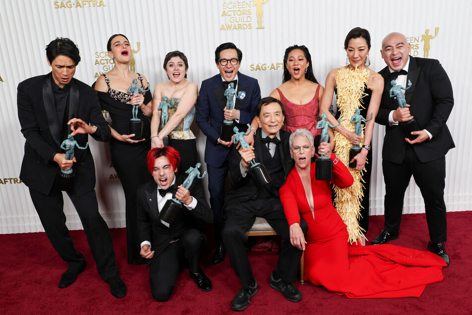 Cast members of Everything Everywhere All at Once Harry Shum Jr., Jenny Slate, Andy Le, Tallie Medel, Ke Huy Quan, James Hong, Stephanie Hsu, Jamie Lee Curtis, Michelle Yeoh, and Brian Le pose with the award for Outstanding Performance by a Cast in a Motion Picture during the 29th Screen Actors Guild Awards.
