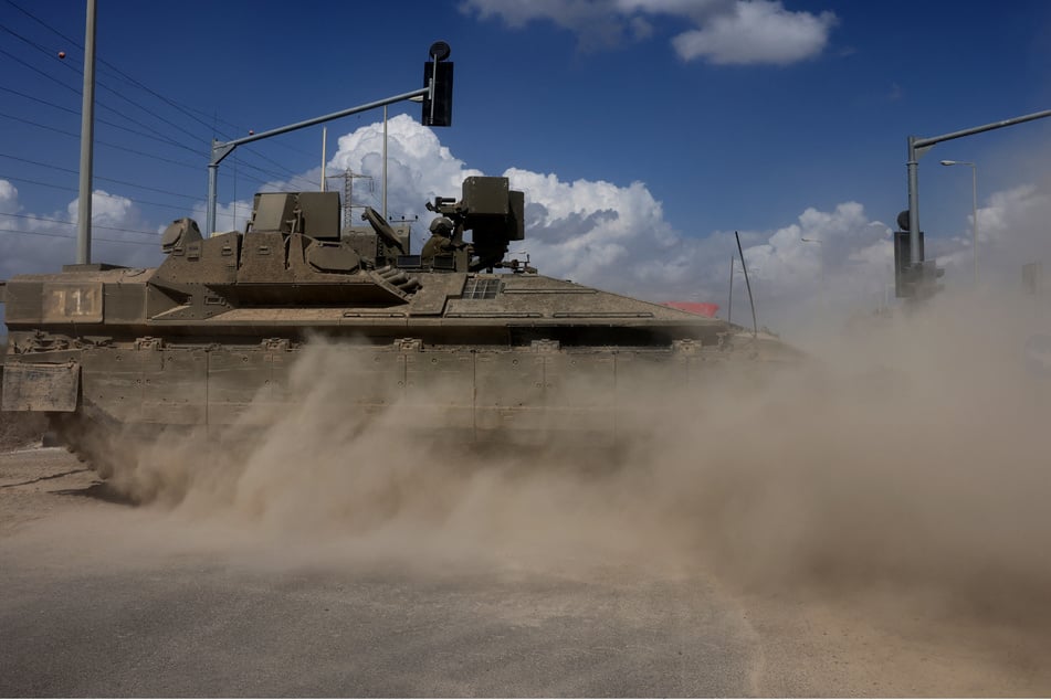 Traffic is stopped as Israeli armored vehicles advance towards the border with the Gaza Strip on October 15, 2023, amid the ongoing battles between Israel and the Palestinian Islamist group Hamas.