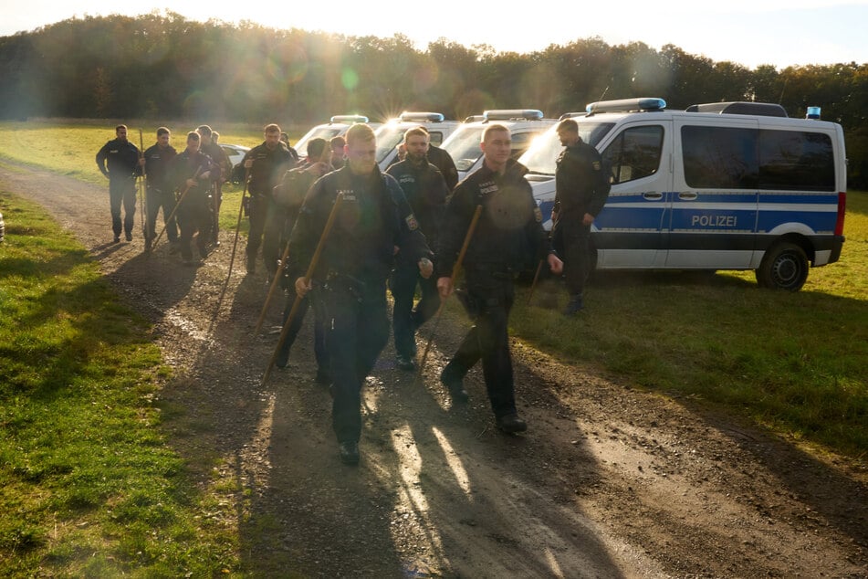 Polizeibeamte durchsuchen den Fundort nach Spuren.