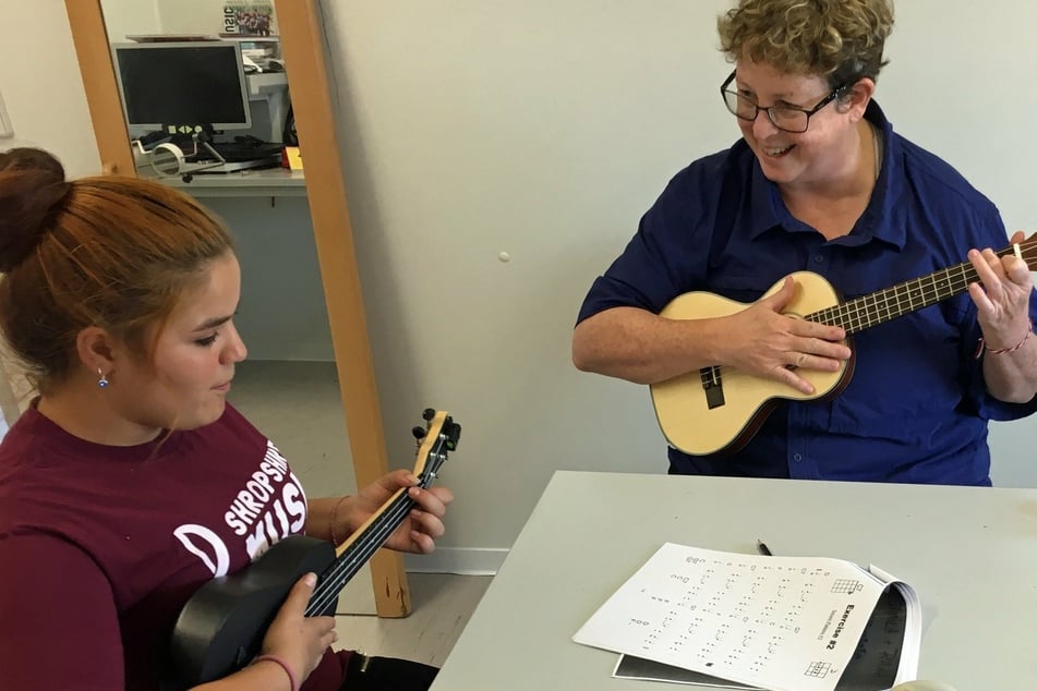 Once Shropshire (r.) is sure her volunteers are proficient in basic music theory, they are ready to run programs in either their local area or abroad.