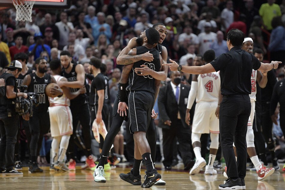 Brooklyn Nets center Nic Claxton hugs forward Royce O'Neale, who scored the winning two-pointer against the Miami Heat.