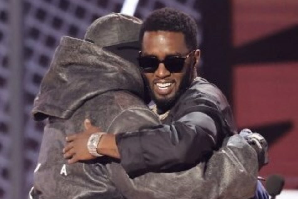 Ye West (l) shows his "brother" Sean "Diddy" Combs love after giving a moving speech during the BET Awards.