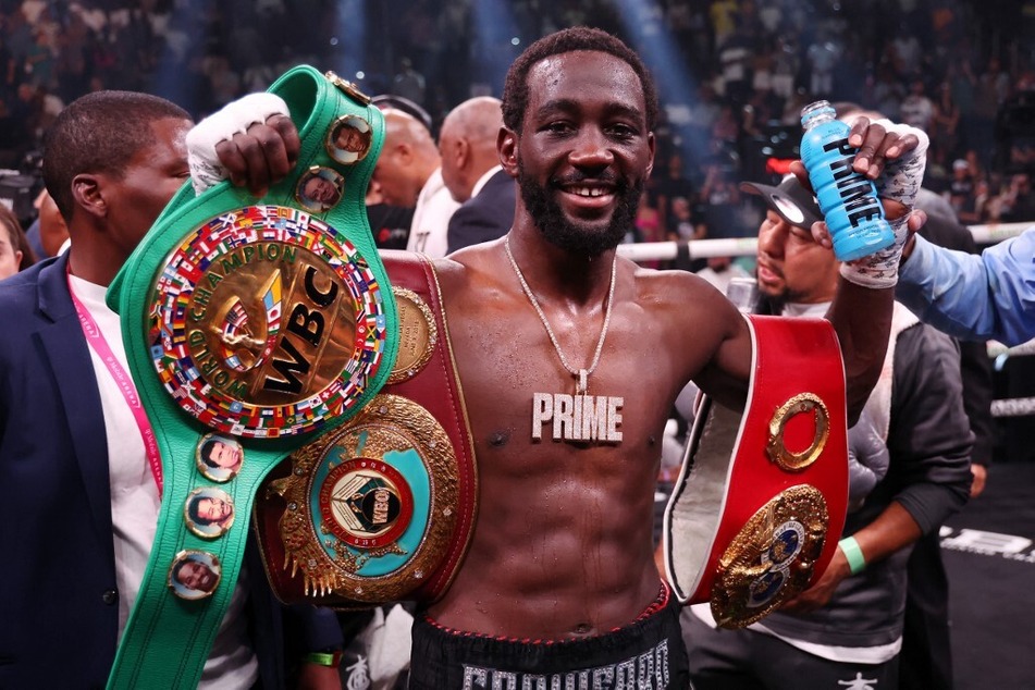 Terence Crawford celebrates with his championship belts after defeating Errol Spence Jr. in the World Welterweight Championship bout at T-Mobile Arena on July 29, 2023 in Las Vegas, Nevada.